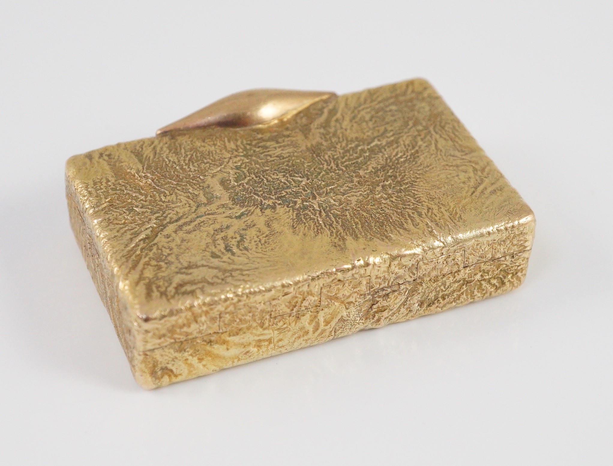 A 1960's 9ct gold Cartier rectangular pill box, with samorodok decoration